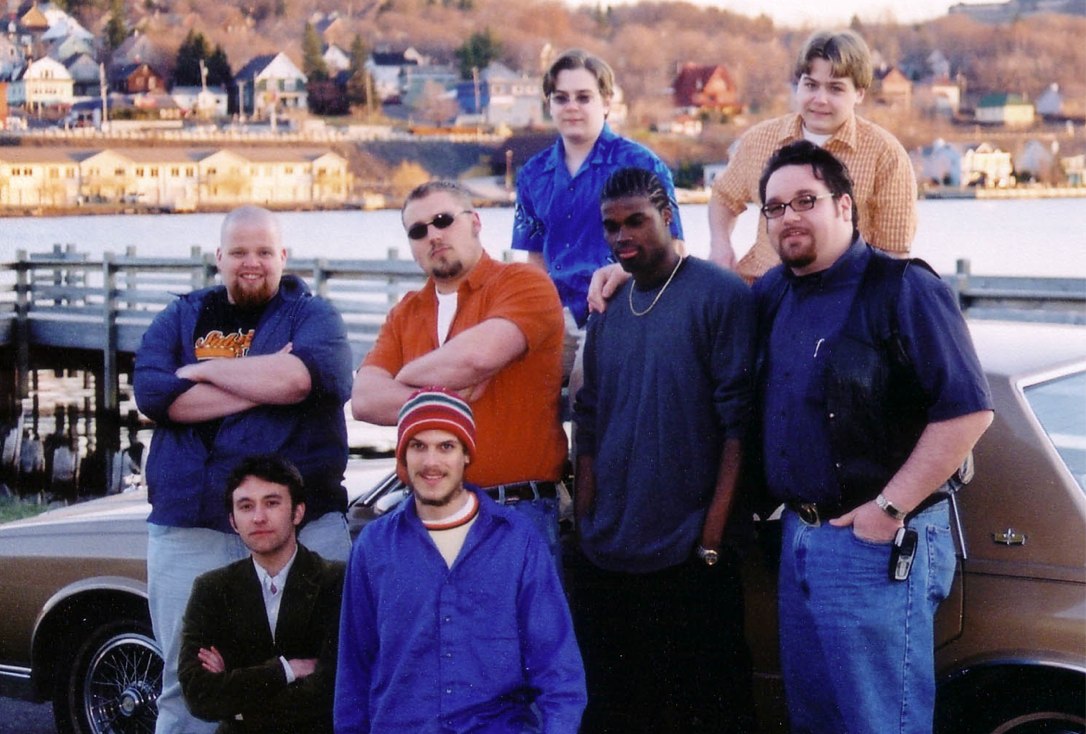 the band posing with a true Detroit Bluesmobile